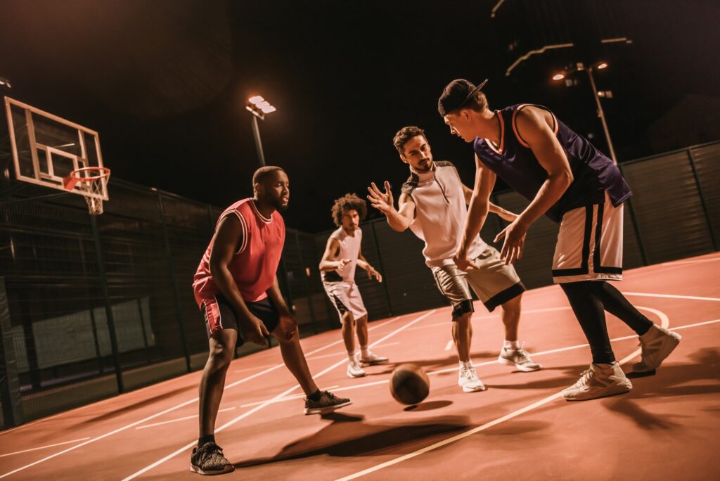Guys playing basketball
